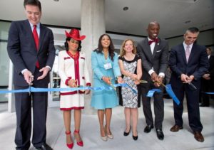 Congresswoman Wilson (second from left) at the building dedication ceremony in 2015. Trump.