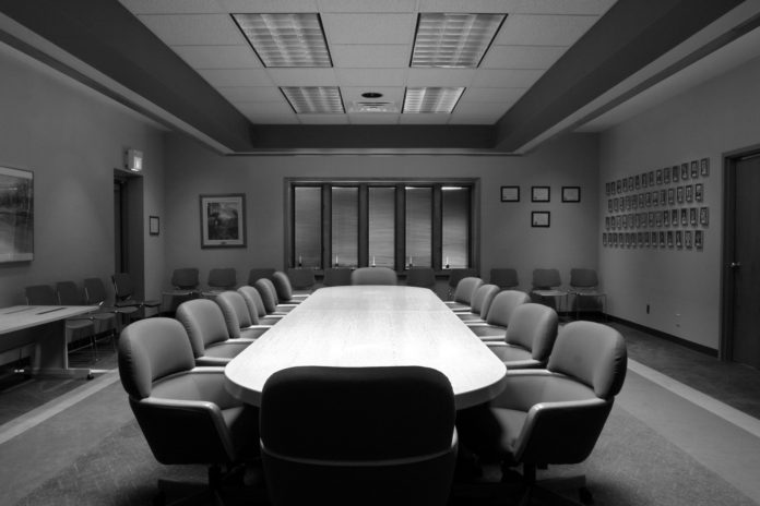 A modern boardroom or meting room in black and white with 12 chairs hedge fund