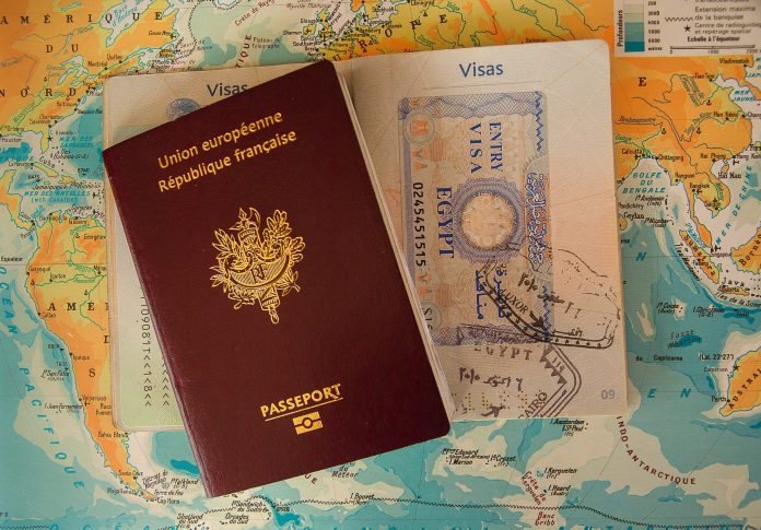 brown passport and visa documents