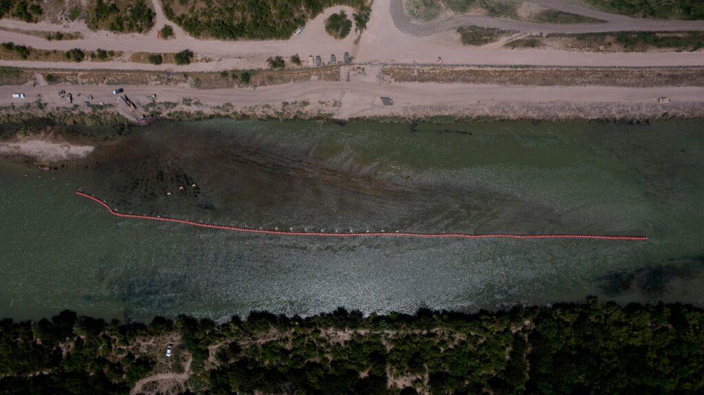 Buoys float on the U.S. side of the Rio Grande in Eagle Pass, Texas on July 20, 2023. The buoys were installed on orders by