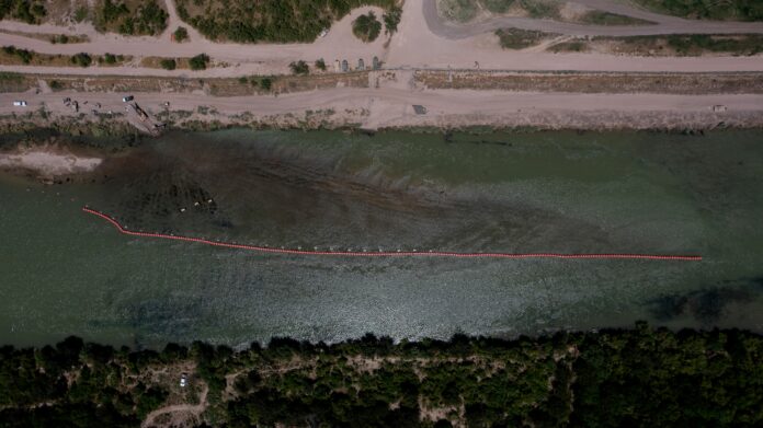 Buoys float on the U.S. side of the Rio Grande in Eagle Pass, Texas on July 20, 2023. The buoys were installed on orders by Buoys float on the U.S. side of the Rio Grande in Eagle Pass, Texas on July 20, 2023. The buoys were installed on orders by