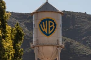Water tower featuring the Warner Bros logo (WB shield) with trees and hills in the background.