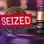 Red 'SEIZED' stamp over a crypto coin with a judge's gavel, signaling cryptocurrency seizure.