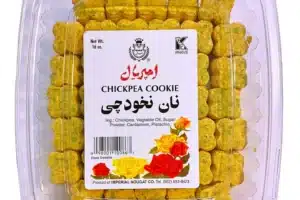 Clear plastic clamshell packaging containing yellow chickpea cookies; front label reads 'CHICKPEA COOKIE' with Persian text and floral design