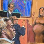 Pregnant woman in a brown dress raises her right hand to swear an oath in a courtroom, while a judge and two suited men observe nearby.