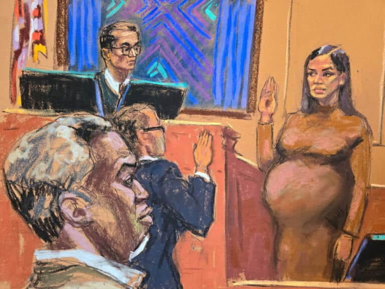 Pregnant woman in a brown dress raises her right hand to swear an oath in a courtroom, while a judge and two suited men observe nearby.