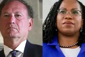 Side-by-side portrait: a man in a dark suit and tie on the left, and a woman wearing glasses and a blue blazer on the right.