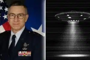 Portrait of a military officer in dress uniform with medals, standing in front of a U.S. flag; a grayscale UFO with beam is shown to the right.
