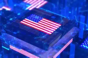 Close-up of a circuit board with a glowing American flag design on a chip in blue tones.