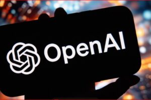 Smartphone held in hand displaying the OpenAI logo on a black screen with a colorful cityscape blur in the background, branding-focused image.