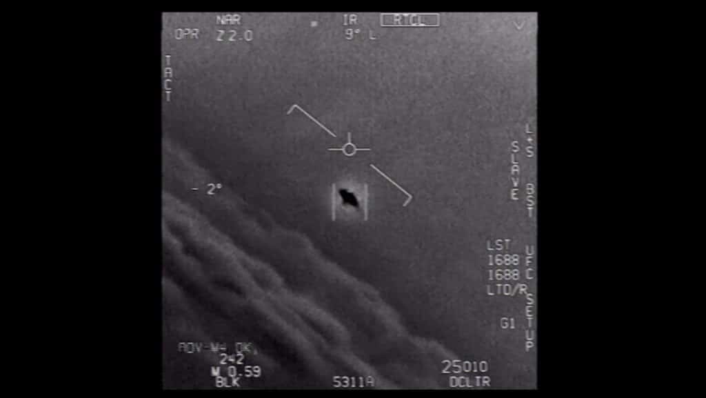 IR screen with targeting reticle centered on a small rectangular target; dark hole in the rectangle, surrounded by flight HUD markings
