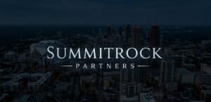 SummitRock Partners logo over a nighttime aerial view of a downtown city skyline