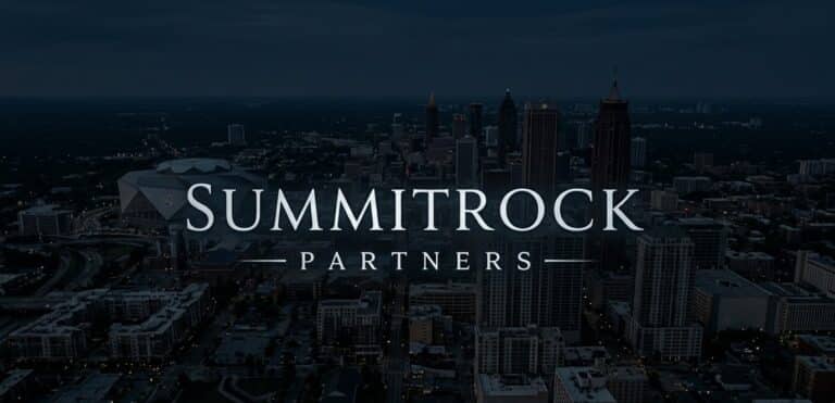 SummitRock Partners logo over a nighttime aerial view of a downtown city skyline