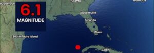 Map showing a red earthquake dot in the Caribbean south of Cuba with a '6.1 MAGNITUDE' label in the top-left corner.