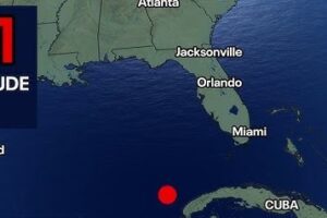 Map showing a red earthquake dot in the Caribbean south of Cuba with a '6.1 MAGNITUDE' label in the top-left corner.