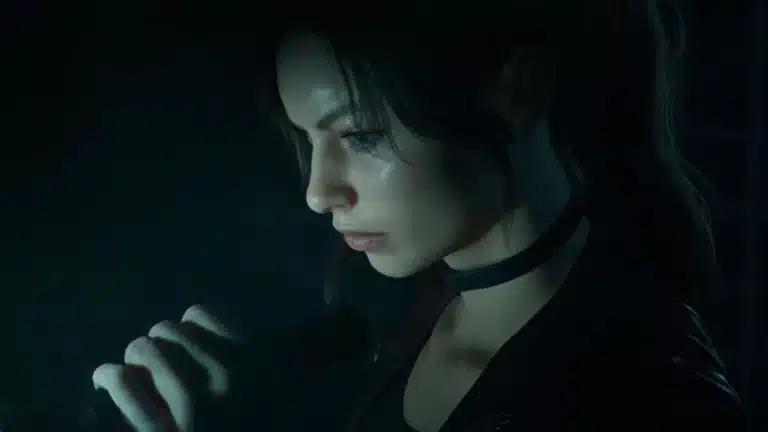 Side profile of a young woman with dark hair and a choker, speaking or singing into a handheld microphone in a dim, moody setting