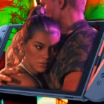 Close-up of a couple embracing in neon-lit colors, with a handheld gaming console (Nintendo Switch) visible in the foreground.
