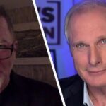Split-screen image of two men: left appears in a casual setting with glasses and a goatee; right in a studio with blue lighting and blazer, suggesting an interview or discussion.