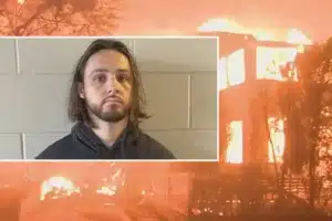 Mugshot-style portrait of a man with shoulder-length hair and beard, inset on a blazing building fire graphic.