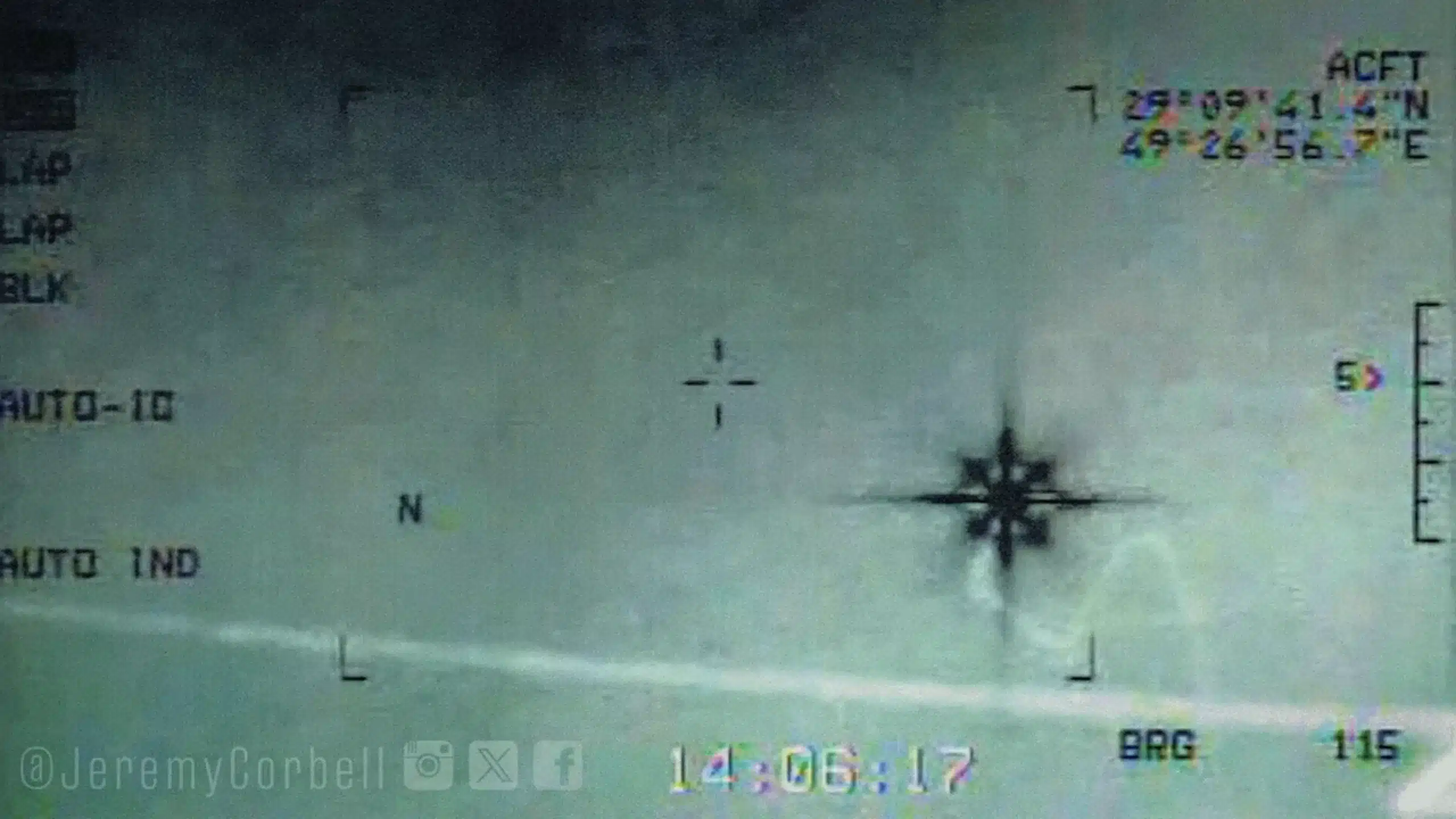 Close-up of an aircraft attitude indicator with horizon line, miniature airplane symbol, and compass-like markings on the right; a faint watermark and dashboard text are visible.