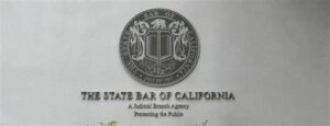 Seal of the State Bar of California featuring a shield with scales and a book, with the text 'The State Bar of California' beneath.
