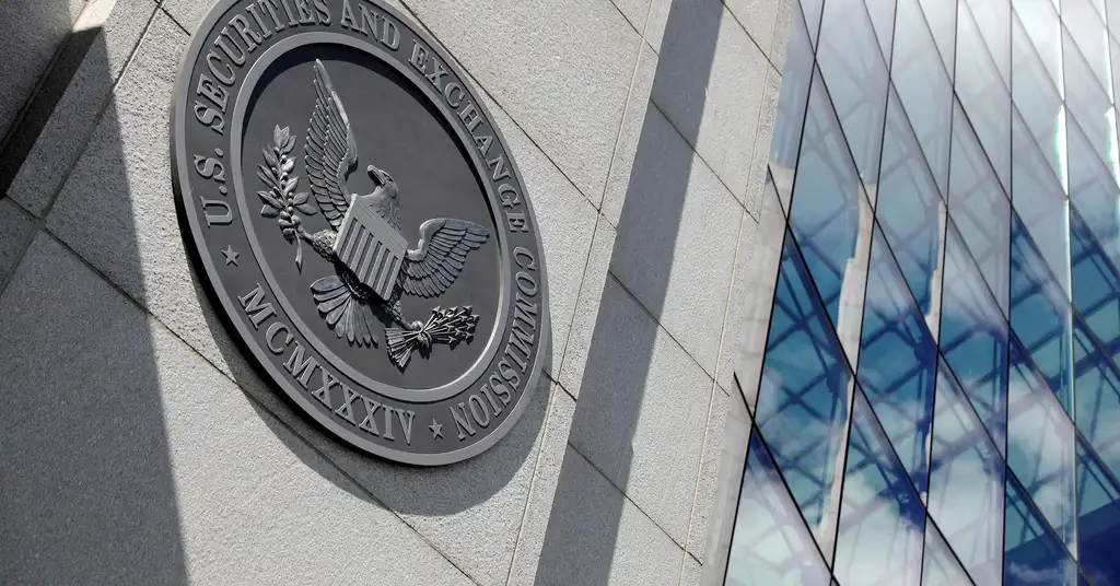 Seal of the U.S. Securities and Exchange Commission on a stone wall beside a glass office building exterior surface.