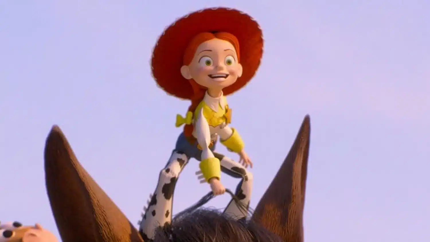 Cowgirl Jessie from Toy Story riding a brown horse against a clear sky, smiling with red hat and yellow accents on her outfit.