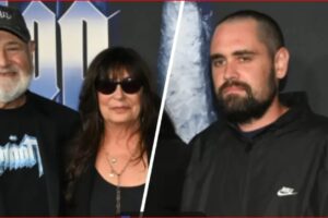 Three people posing for a photo: an older man with a white beard and cap on the left, a woman in sunglasses in the middle, and a bearded man in a black hoodie on the right, split by a diagonal line in the backdrop.