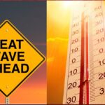 Yellow warning diamond sign reading 'HEAT WAVE AHEAD' beside a bright thermometer under a sunset sky, signaling extreme heat.