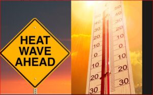 Yellow warning diamond sign reading 'HEAT WAVE AHEAD' beside a bright thermometer under a sunset sky, signaling extreme heat.