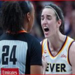 Two female basketball players argue on the court: one with jersey number 24 facing away, the other in a white Fever jersey shouting.
