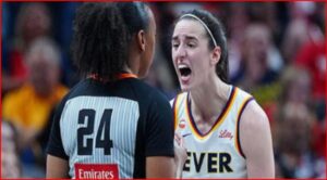 Two female basketball players argue on the court: one with jersey number 24 facing away, the other in a white Fever jersey shouting.