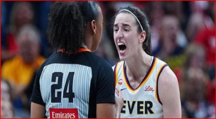 Two female basketball players argue on the court: one with jersey number 24 facing away, the other in a white Fever jersey shouting.