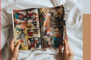 Person's hands hold open a colorful comic book laid on white sheets, panels show superheroes in action.
