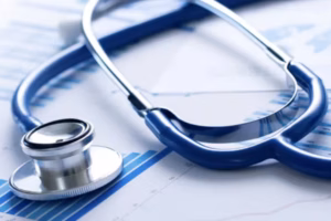Stethoscope resting on medical charts and graphs, symbolizing healthcare data analysis.