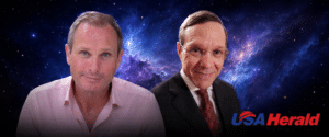 Two men pose together against a starry space backdrop with the USA Herald logo in the bottom right corner.