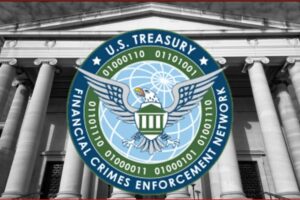 FinCEN seal (U.S. Financial Crimes Enforcement Network) over a neoclassical government building with columns.