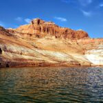 Low water exposes pale rock walls along Lake Powell near Page, Arizona.