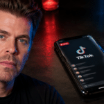 Editorial composite of Perez Hilton beside a smartphone displaying TikTok Live as emergency lights reflect in the background.