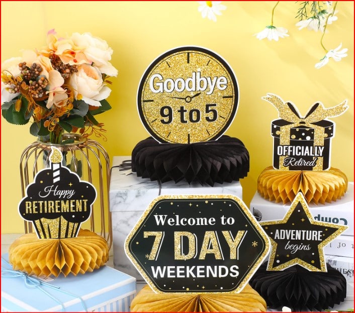 Colorful retirement party scene with gold and black decorations, signs say 'Goodbye 9 to 5' and 'Welcome to 7 Day Weekends' against a yellow backdrop.