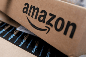Close-up of an Amazon cardboard shipping box with the Amazon logo and blue Prime tape.