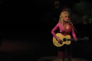 Dolly Parton performs onstage with her guitar at Wolf Trap in 2011.