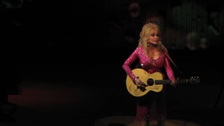 Dolly Parton performs onstage with her guitar at Wolf Trap in 2011.