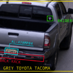 Rear view of a grey Toyota Tacoma with a back rack and Raiders sticker; license plate 47MP04; timestamp and coordinates overlaid on image.
