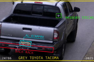 Rear view of a grey Toyota Tacoma with a back rack and Raiders sticker; license plate 47MP04; timestamp and coordinates overlaid on image.