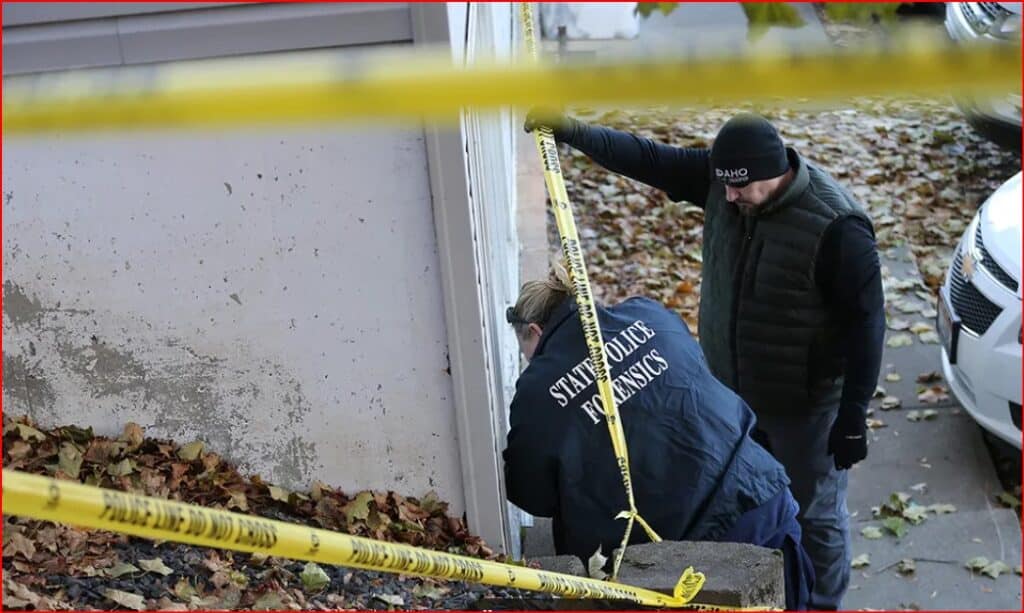 Forensic investigators at a crime scene outside a house, yellow police tape in the foreground.