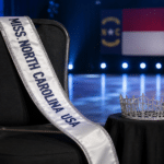 Empty Miss North Carolina USA chair with the titleholder’s sash and crown set aside.