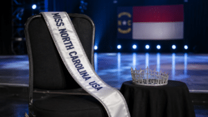 Empty Miss North Carolina USA chair with the titleholder’s sash and crown set aside.