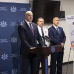 Pennsylvania Attorney General Dave Sunday speaks beside a board displaying details about the alleged Penn State cocaine ring.
