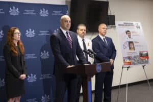Pennsylvania Attorney General Dave Sunday speaks beside a board displaying details about the alleged Penn State cocaine ring.